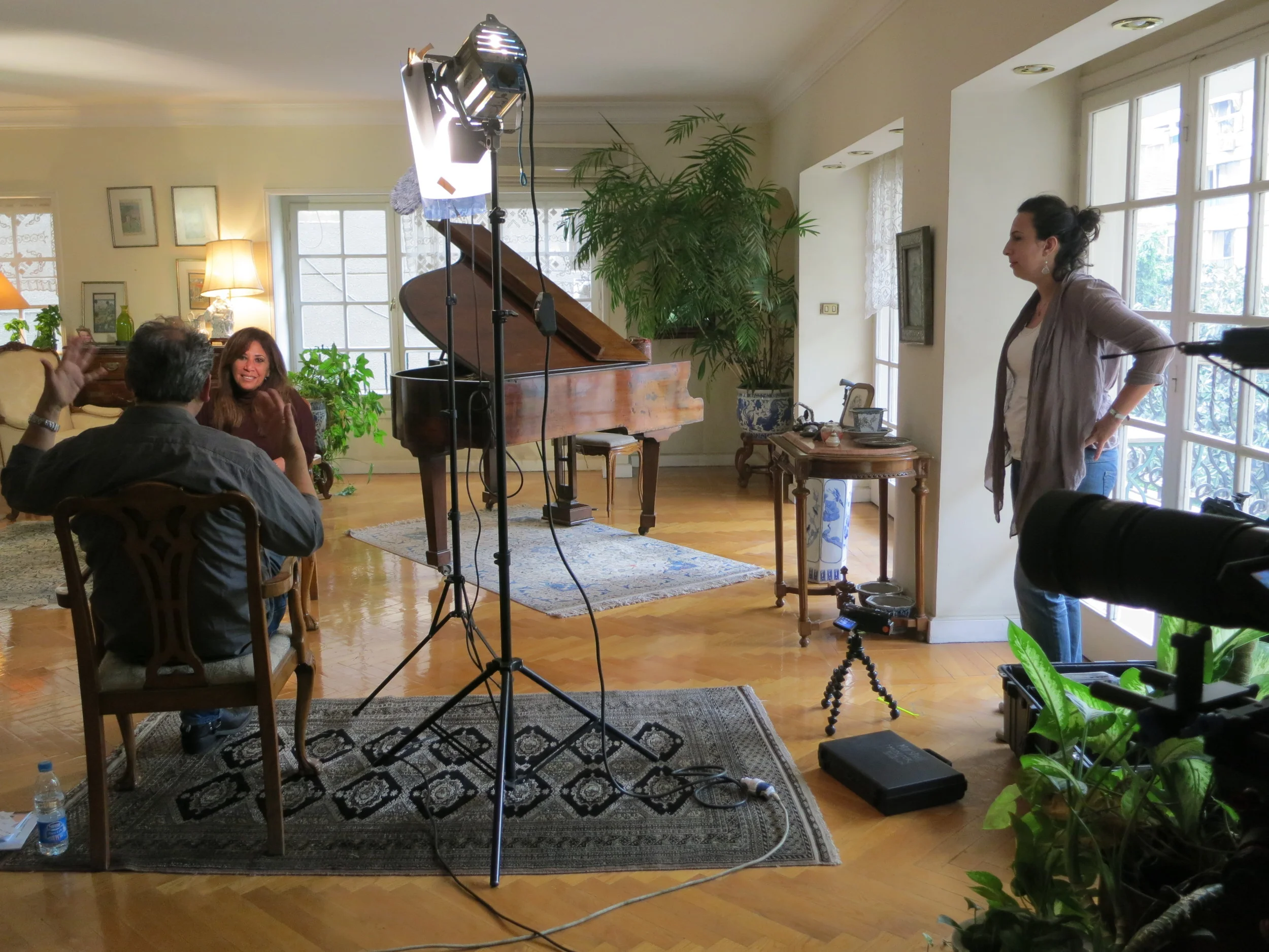 Co-director  Racha Najdi  looking on as director  Mark Nickolas  interviews famed Egyptian journalist  Shahira Amin  in her Maadi (Cairo) home. 