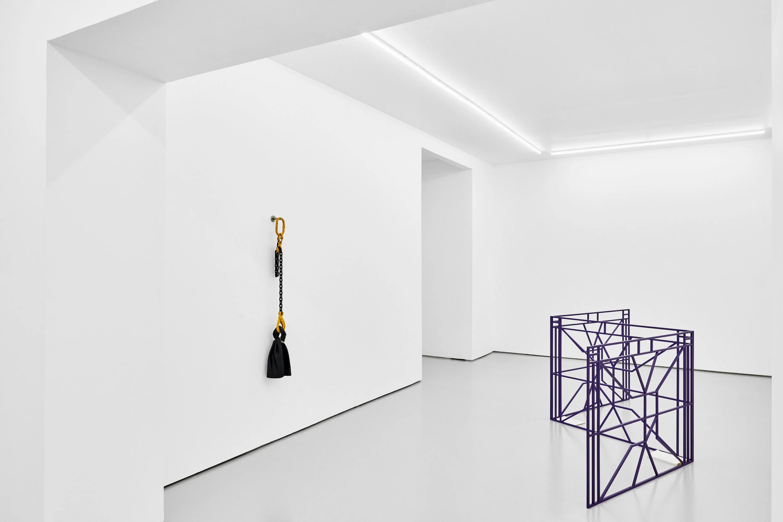 Untitled # 6 from the series Holding my breath , 2019, leather, chain sling, jewellery chain, clamp with feathers, 100 x 30 x 30 cm