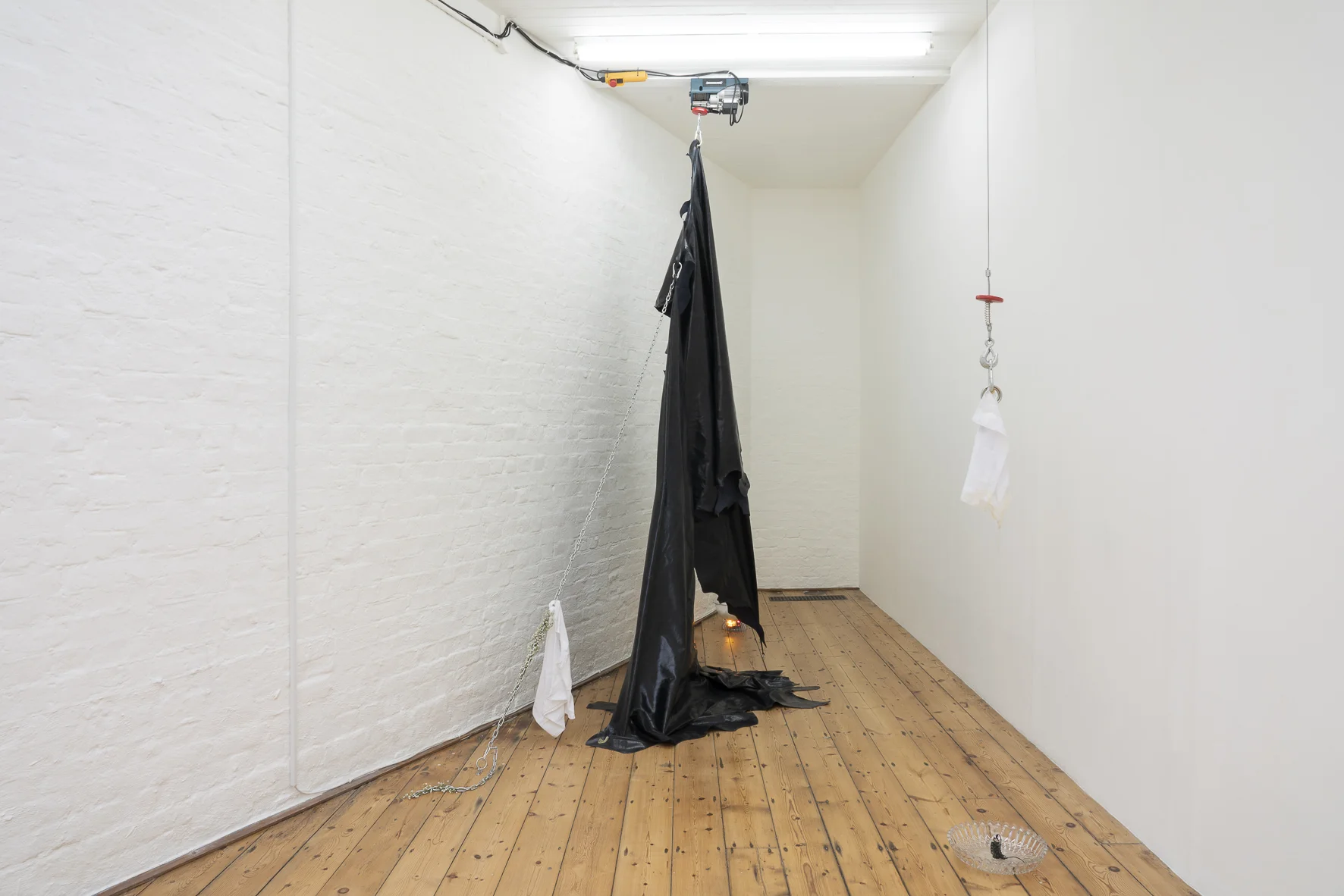 Anna McMahon, Of doubts and dreams , 2019, Dimensions variable Electric hoists, leather, cocktail fountain, baby’s breath (gypsophila), powdered milk, chain, cotton t-shirt, finger condoms, cock rings, bespoke handkerchief, nipple clamp with chain, weight, crystal bowl, English soft set honey, chair, trainers, human hair. Photograph: Manuela Barczewski