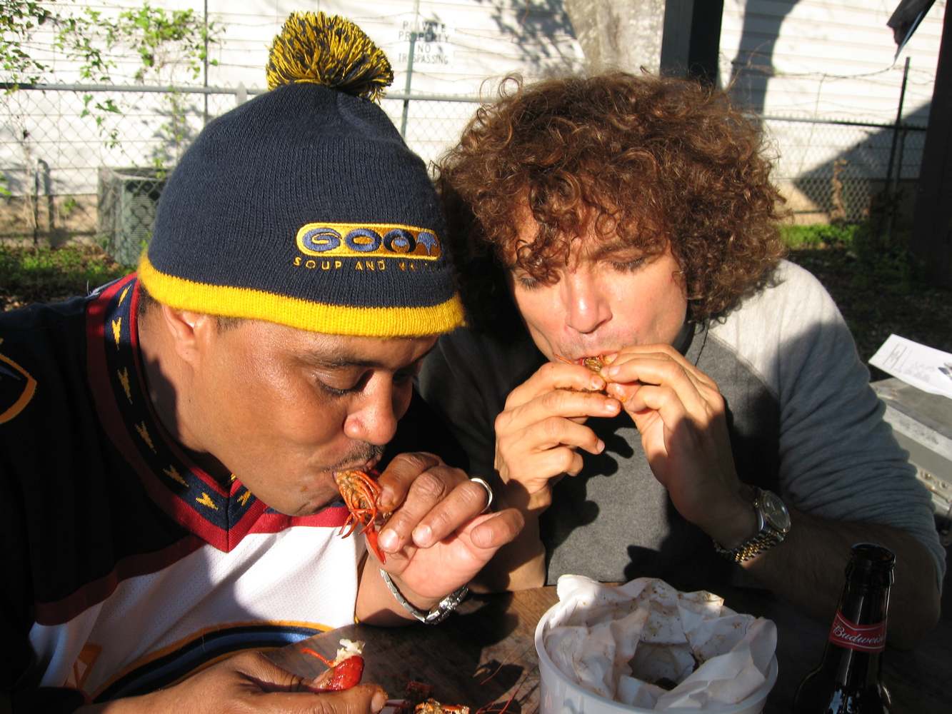 Efrem “ET” Towns of the Dirty Dozen Brass Band and composer Anthony Marinelli eating crawfish on a river bank near Bismeaux Studio, Austin, Texas, 2006