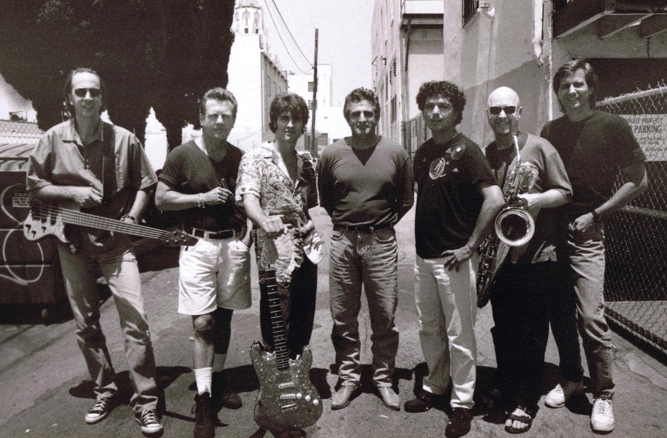 L to R Fer Bos, John “Juke” Logan, Russ Parrish, John Herzfeld, Anthony Marinelli, Brandon Fields and Mark Curry (engineer) behind Anthony’s studio, Hollywood, CA, 1997
