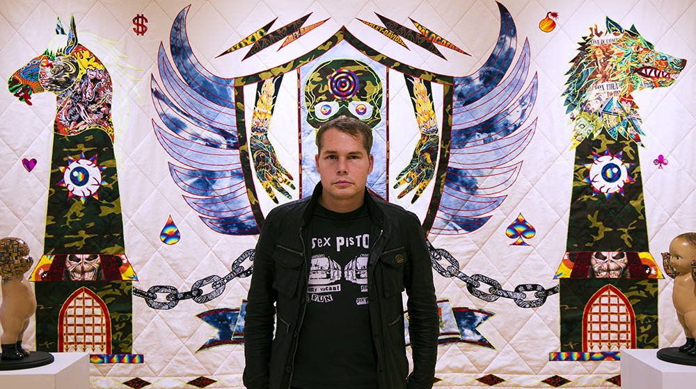 Shepard Fairey in front of work by Ben Venom