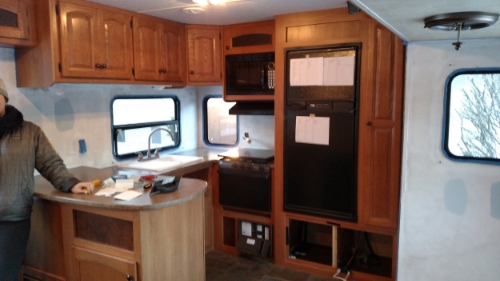 In this picture: new and old color paint testing (under window and kitchen cabinets), massive to do list on fridge, my arm bundled under 7 layers to keep out the NY chill 