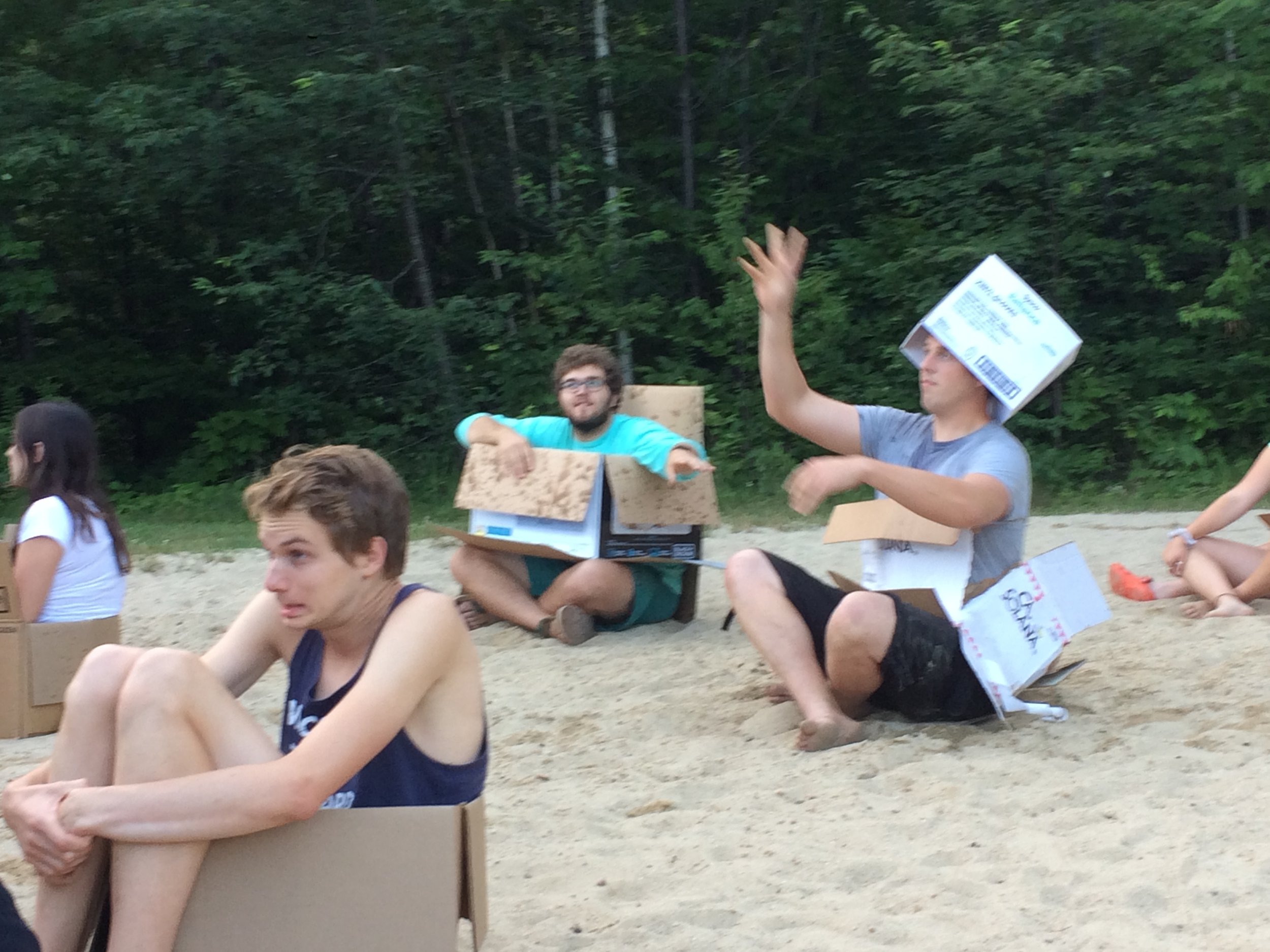 Some staff playing human-sized battleship (campers are launching water balloons at them from across a volleyball net draped in tarps) 