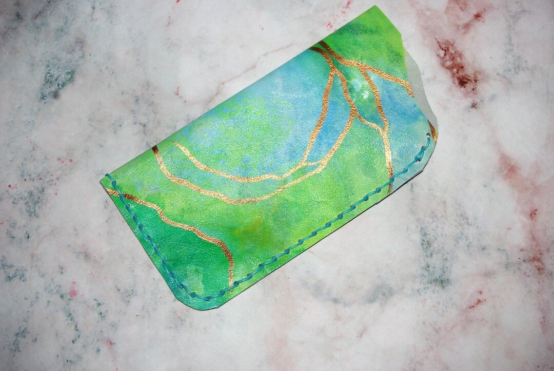 From scrap leather to a hand painted glasses pouch 🌿♻️ being able to bring my art to life through leather still blows my mind 🤯💚