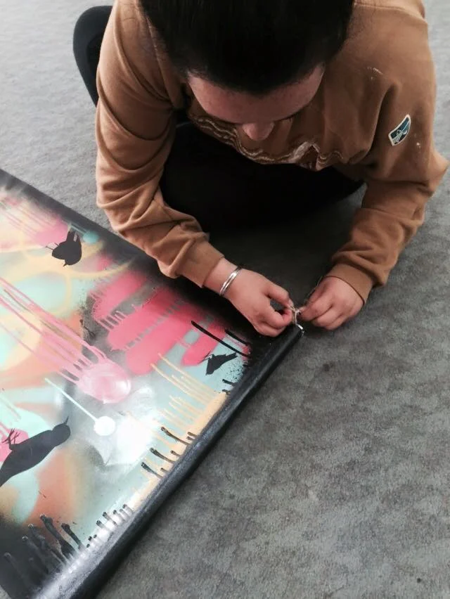 Kaea Graham getting her painting ready to hang for phase two.