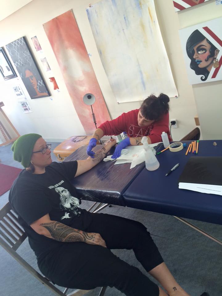 Moko artist Sian Montgomery-Neutze tattooing clay artist Stevei Houkamau.