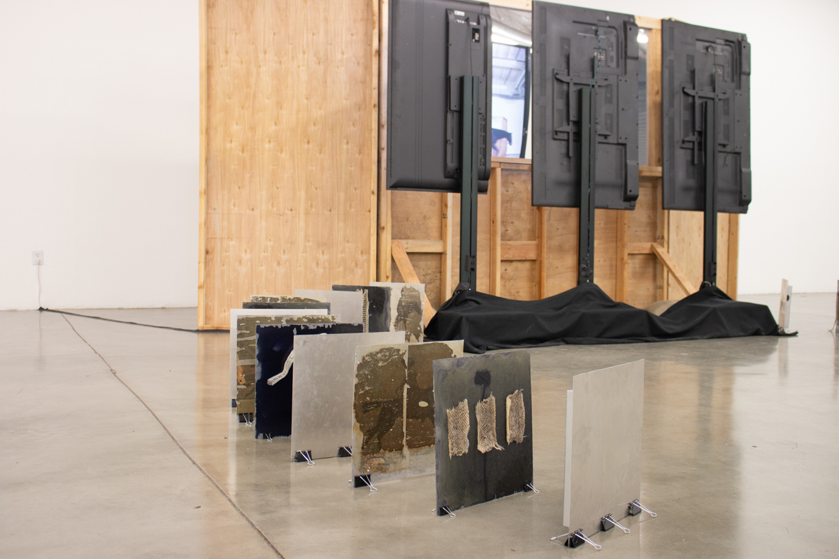 “Untitled Mirage 2, or an Exhibitionary Complex (The Lynda and Stewart Resnick Cultural Center)” Wood Structure, One Way Mirror, Sandbags, Three Channel Video Installation. 2017 work in situ, completed 2018.