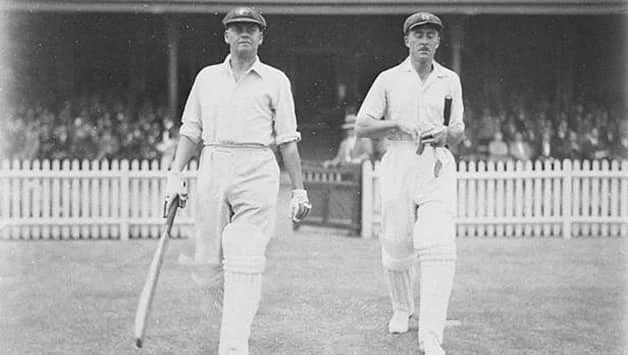 Bill Woodfull (left) and Vic Richardson walking out to open the batting in the final Bodyline Test. Photo courtesy: Wikimedia Commons.