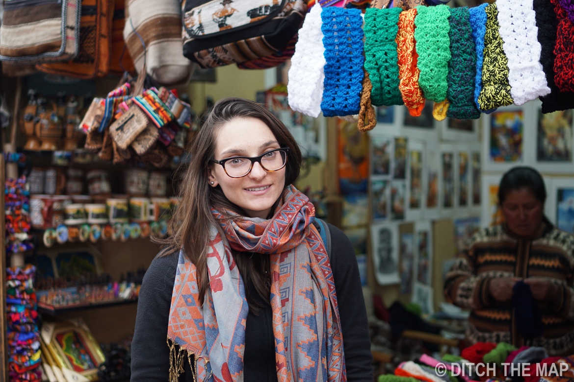 Sylvie shows off her new scarf in a market in Cusco, Peru