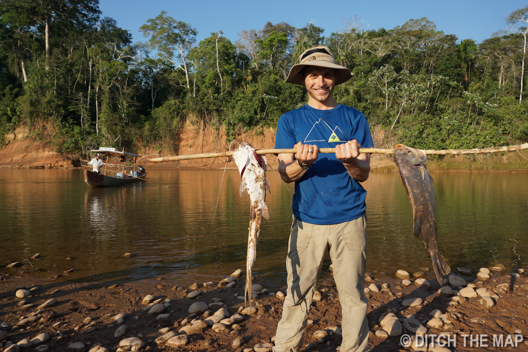 Scott holds our group's catch along the RIVER DURING OUR TRIP TO THE AMAZONIAN JUNGLE, BOLIVIA