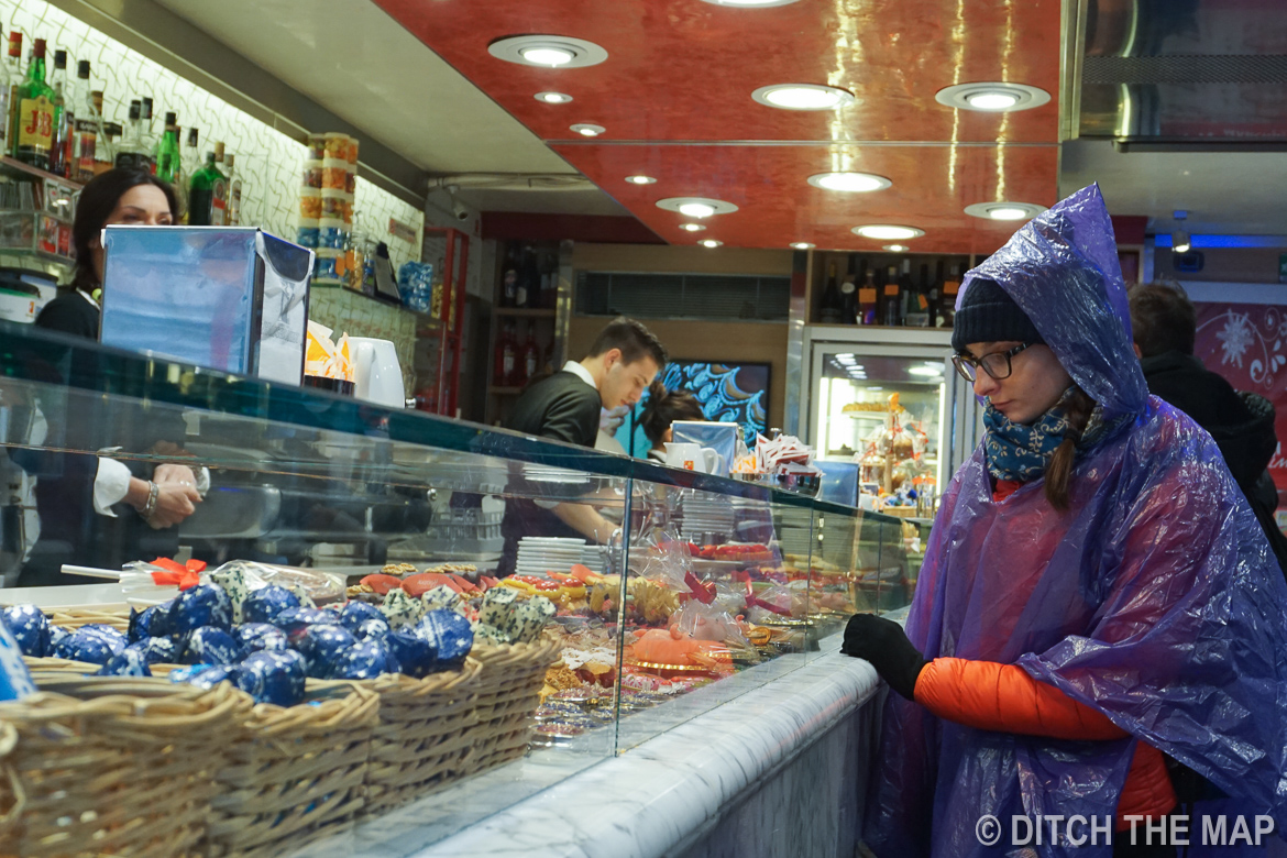 Sylvie eagerly awaits some pastries in Venice, Italy