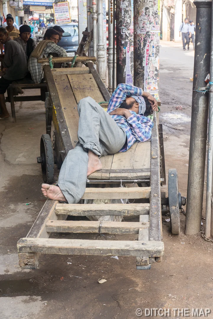 Sleeping before a day of work in Delhi, India