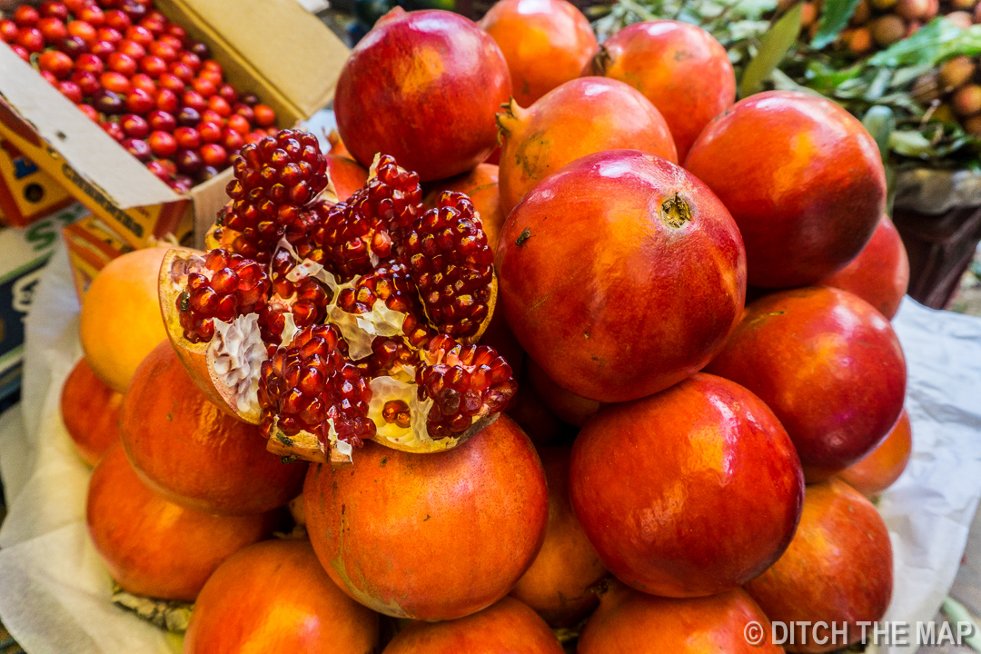 Enjoying a Pomegranate at a Market in Mumbai, India