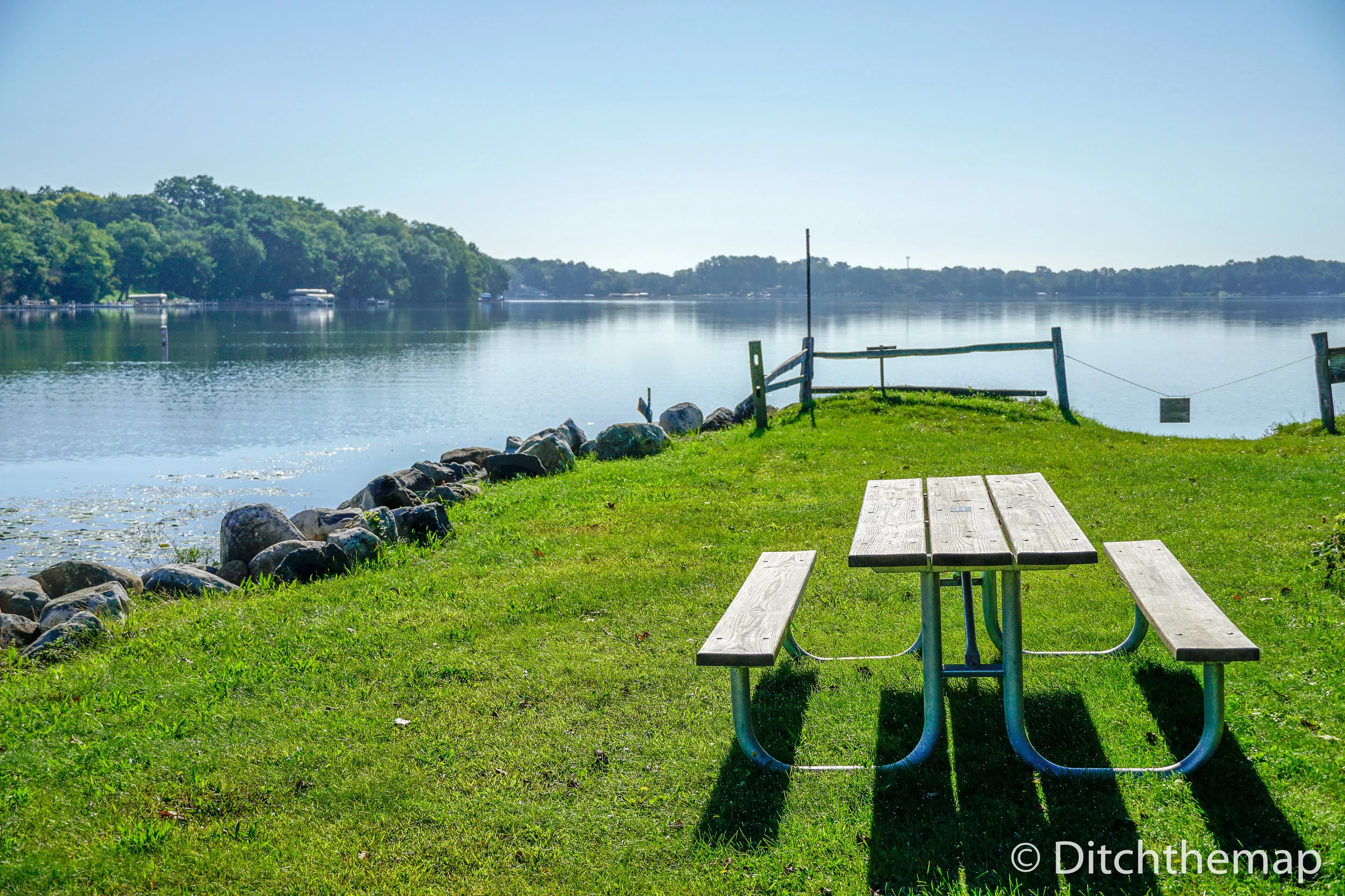 Picnic Table on Green Grass near Lake 
