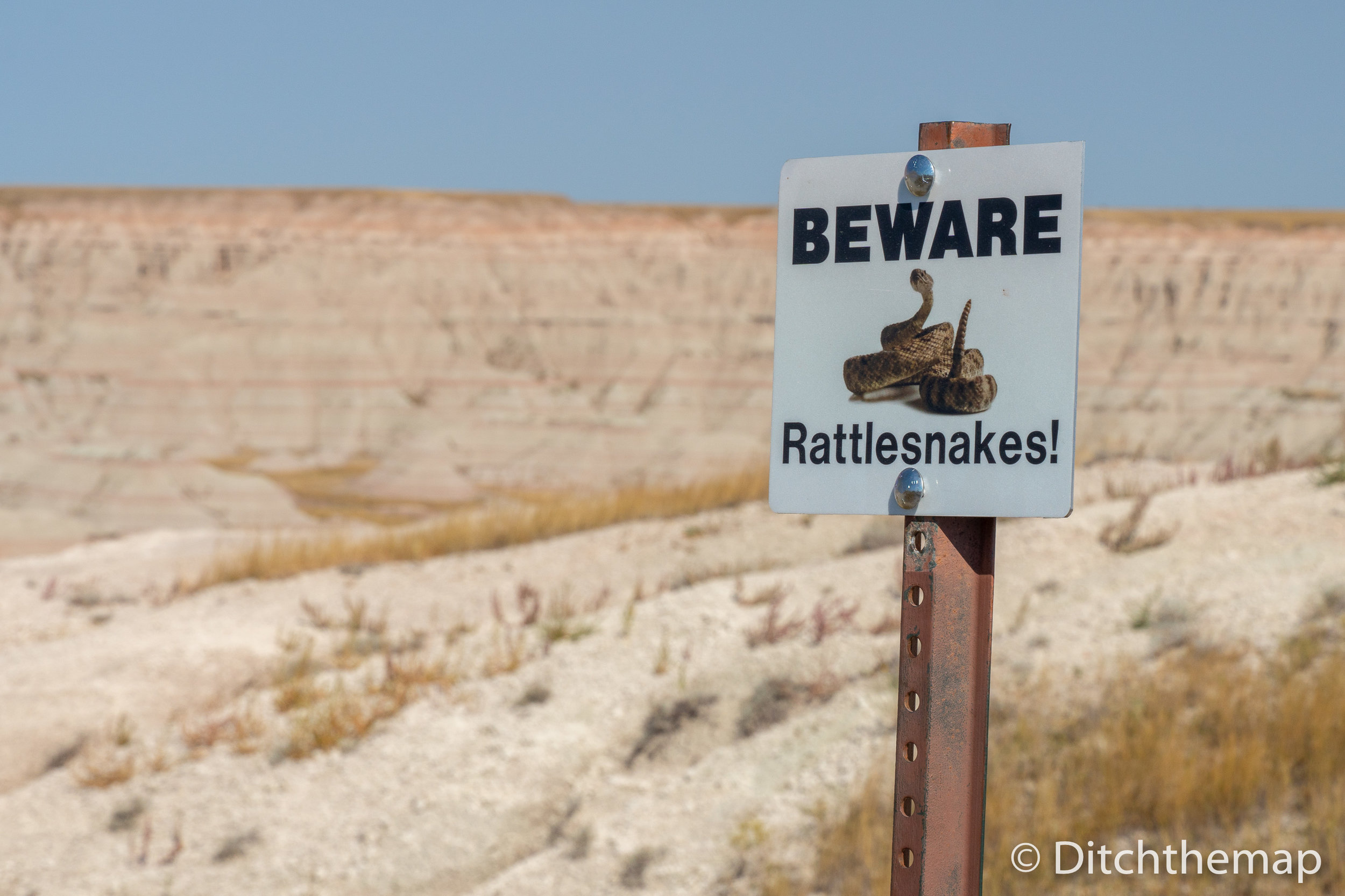 Beware of Rattlesnakes signpost in the Badlands South, Dakota