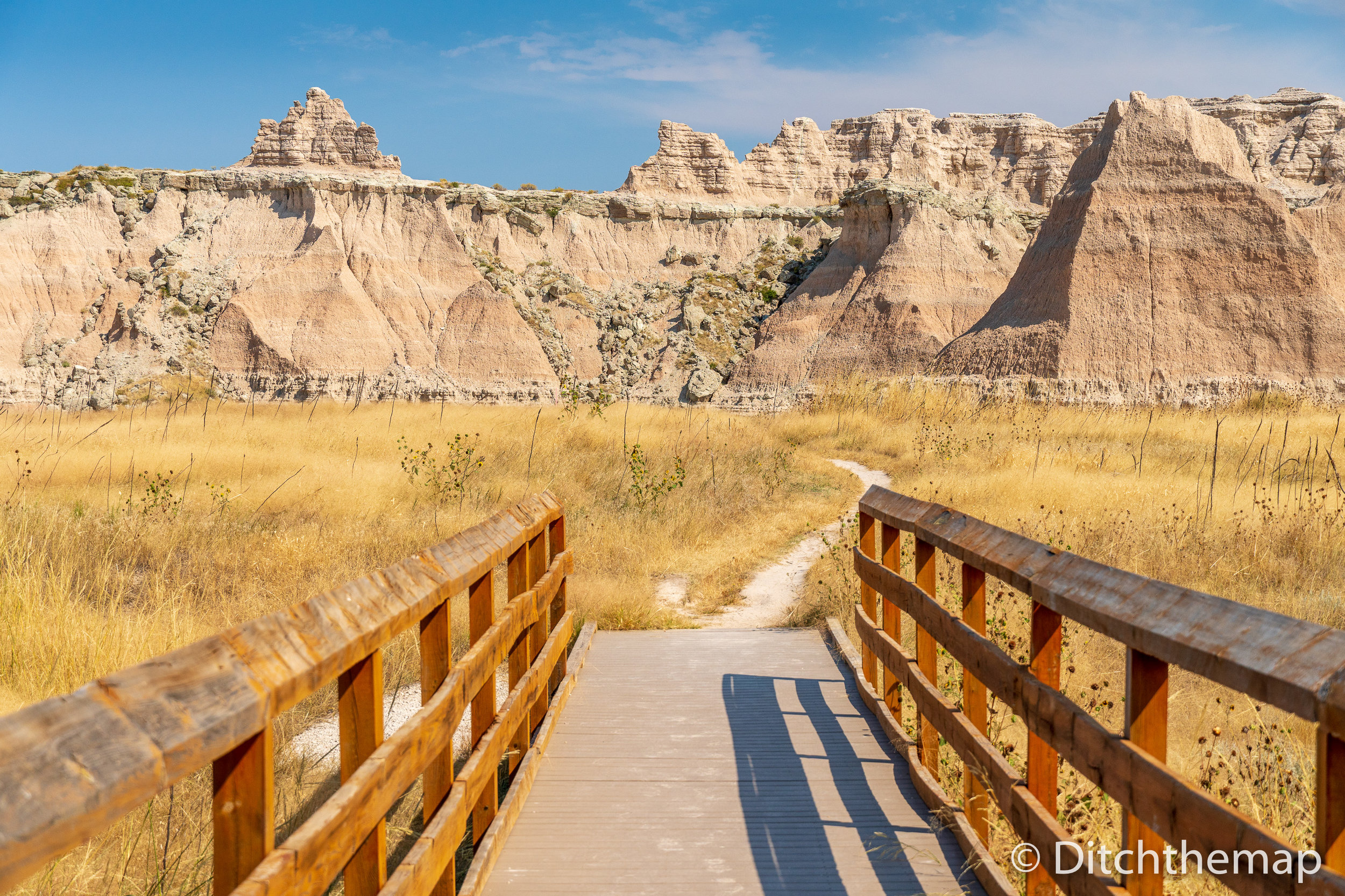 Panoramic View of Badlands Geological Features with Bridge in fo