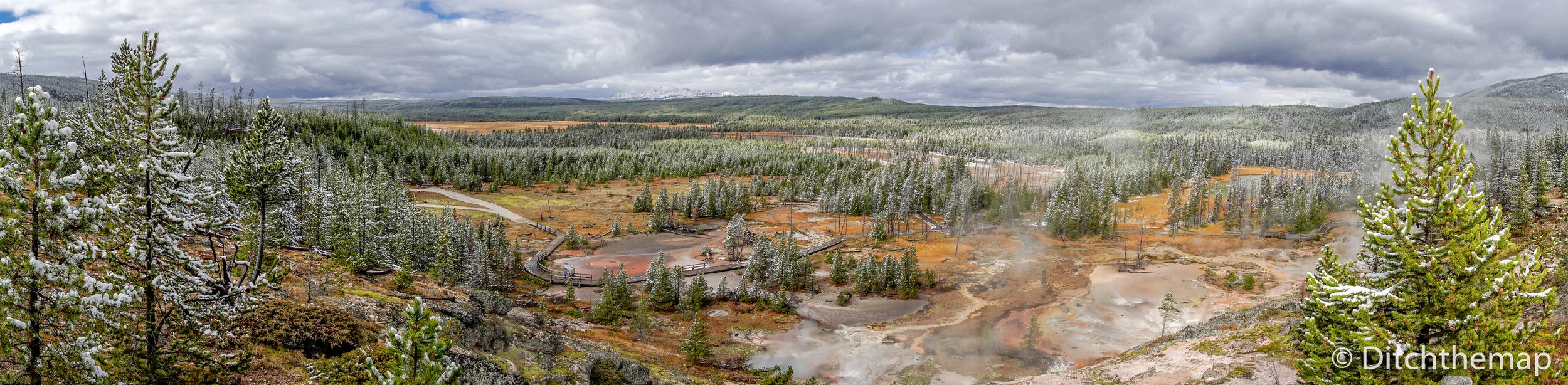 Panoramic view of Yellowstone landscape of geyser  pools and mud