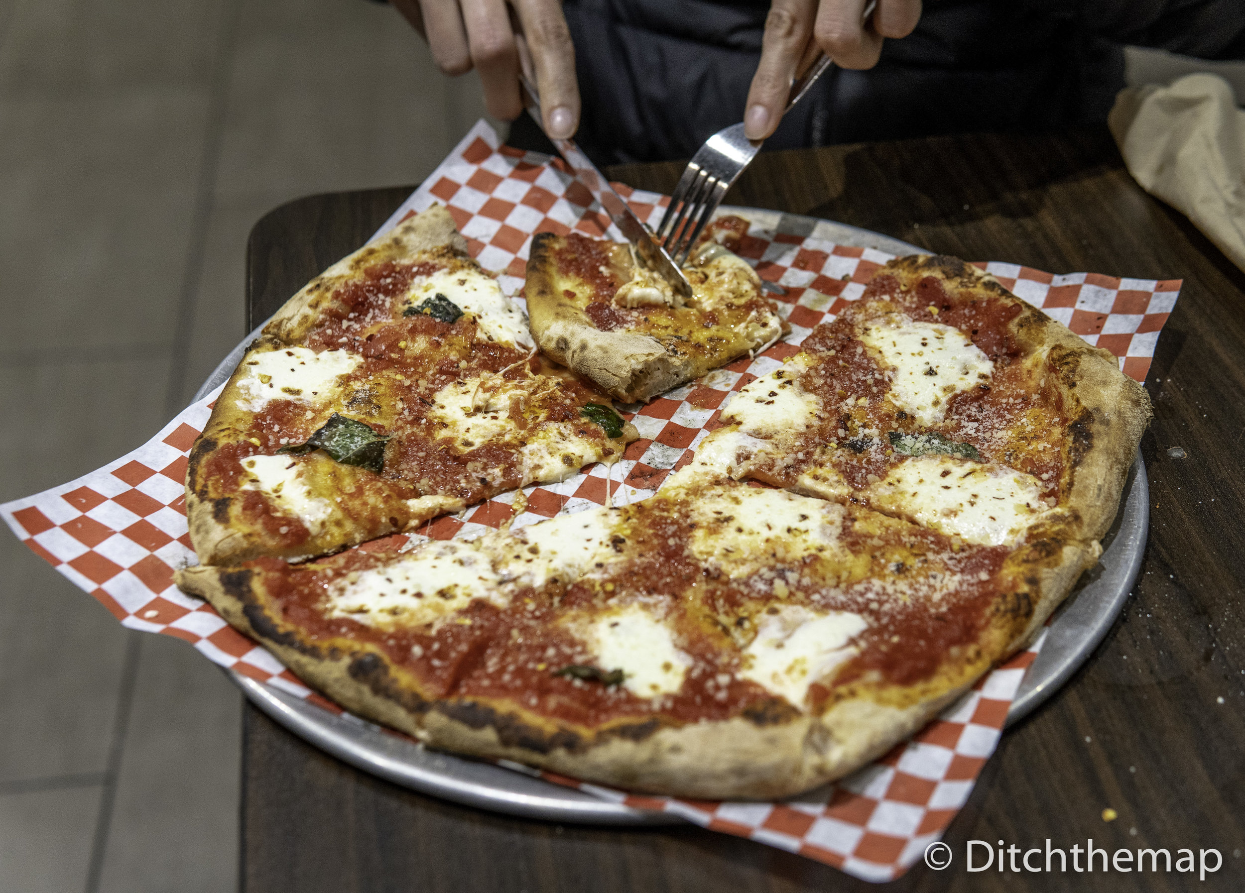 Cutting slice of cheese pizza
