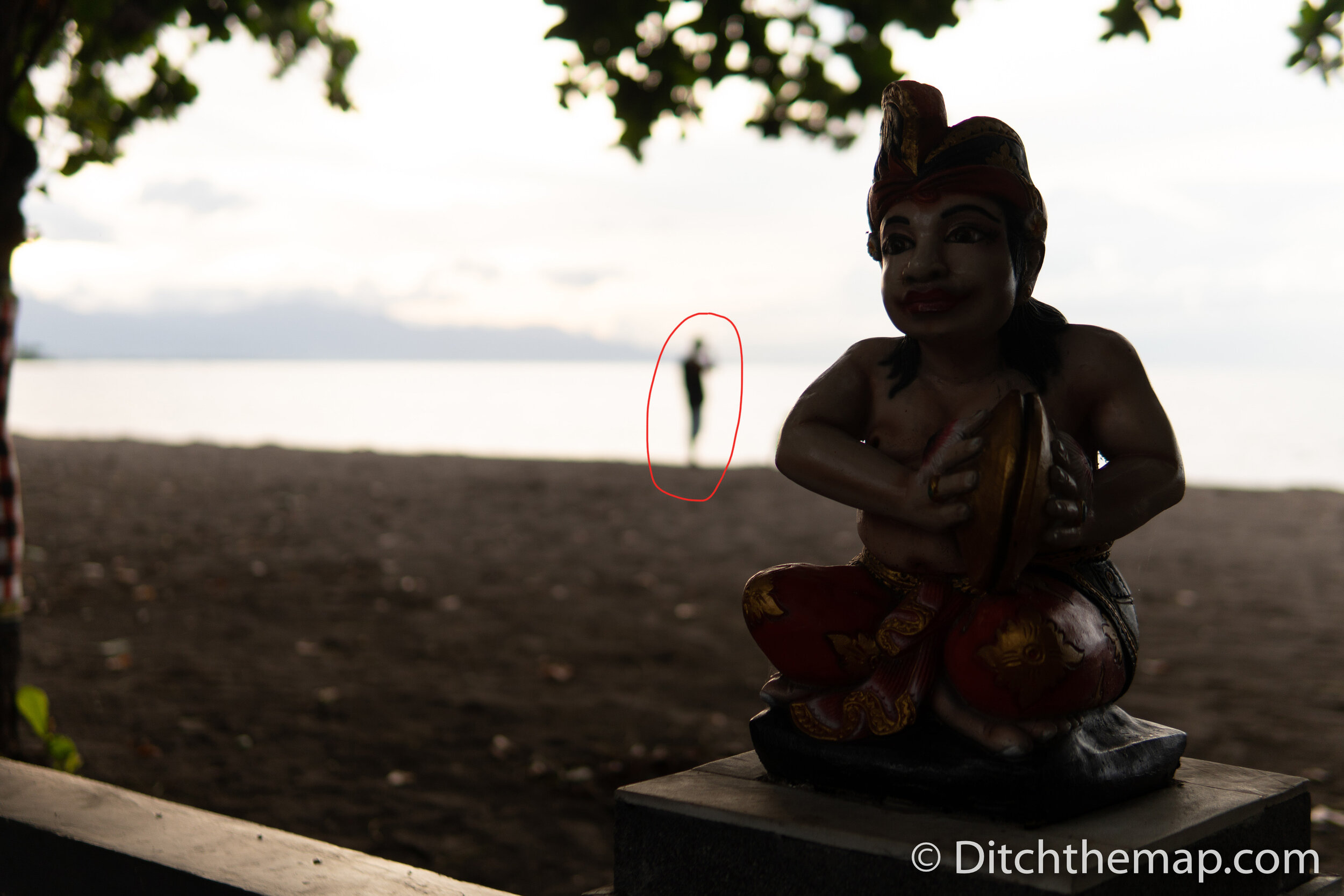 Colorful Hindu Statue at Beach with sunset in background