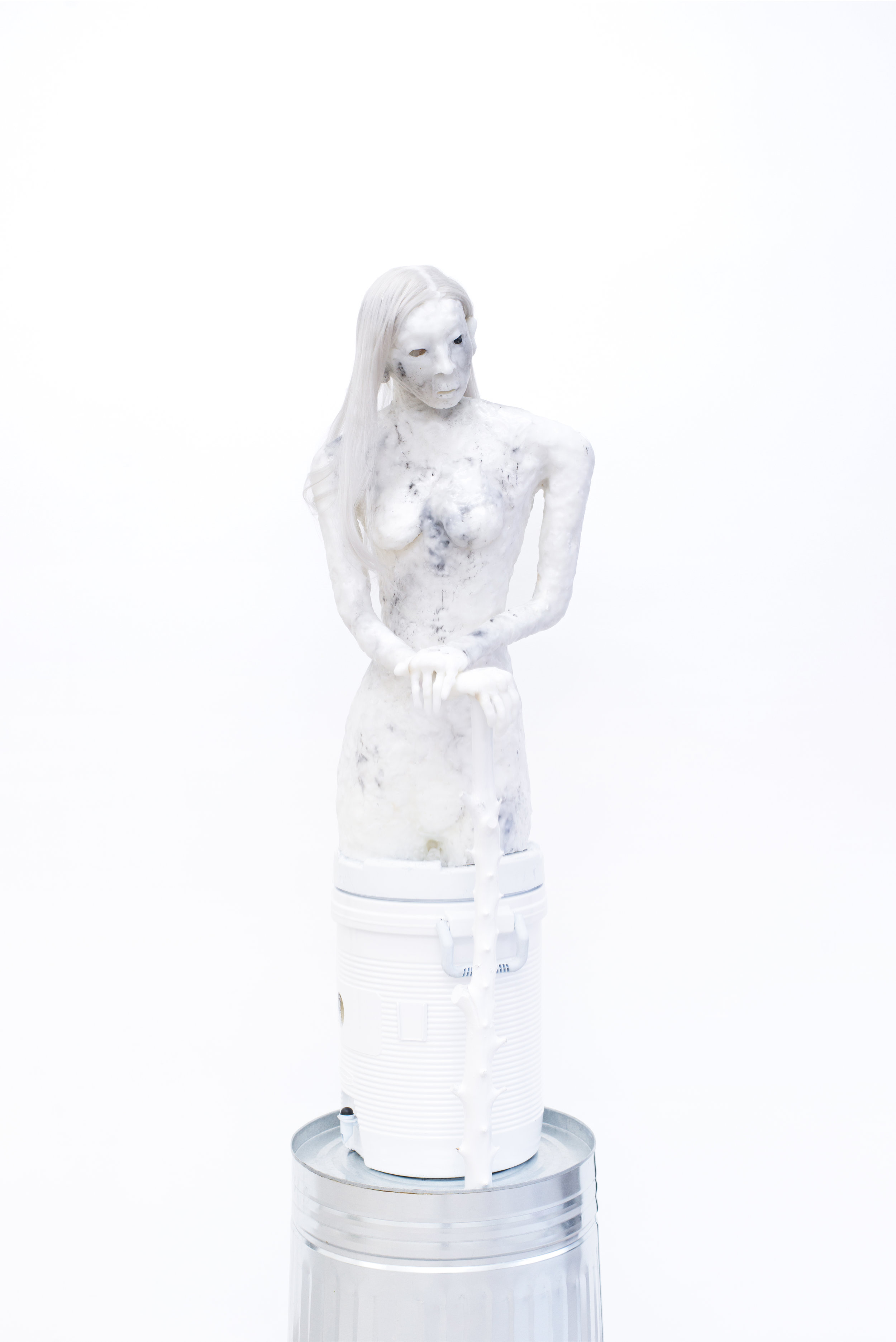 Ian Swanson Younger Dryad Swamp Cooler, 2016 PVC, foam, PCL plastic, water cooler, London Plane branch, epoxy enamel, 20 sided die, polished fate, synthetic hair, dry ice