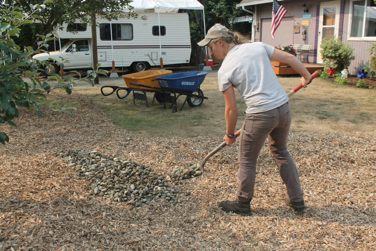 Tessa Anton puts the finishing touches on a bothell rain garden