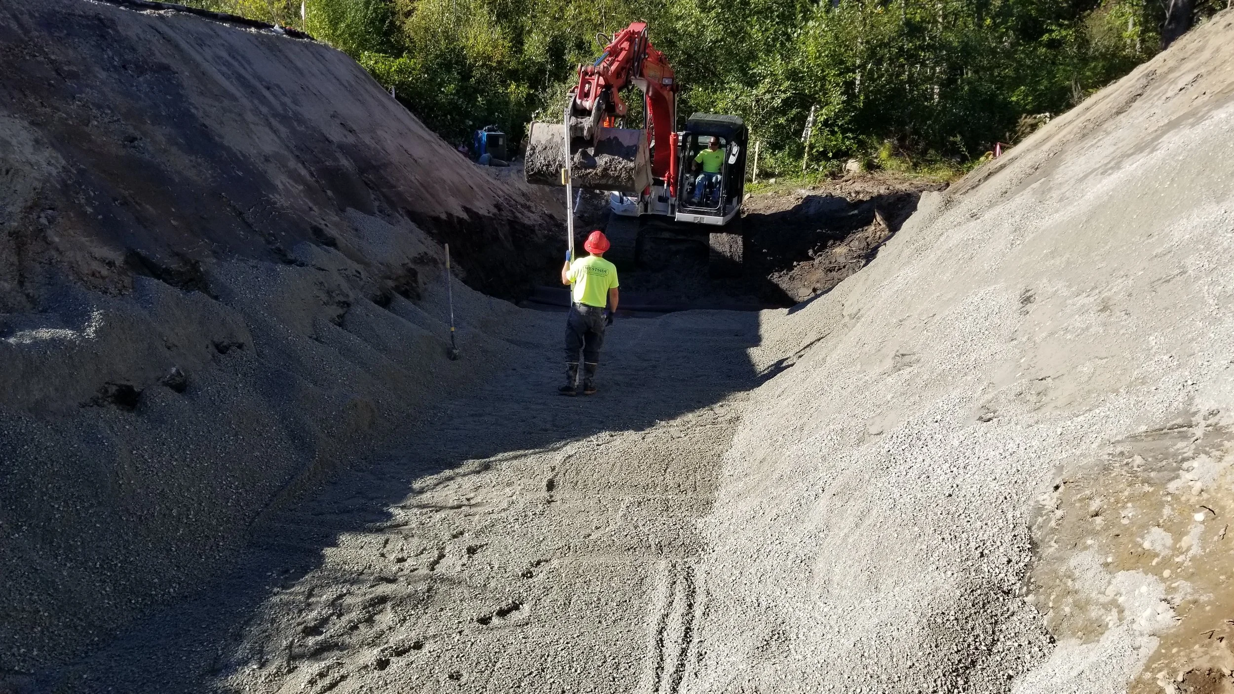 The contractors emptied and leveled a very large hole before placing the new culvert.