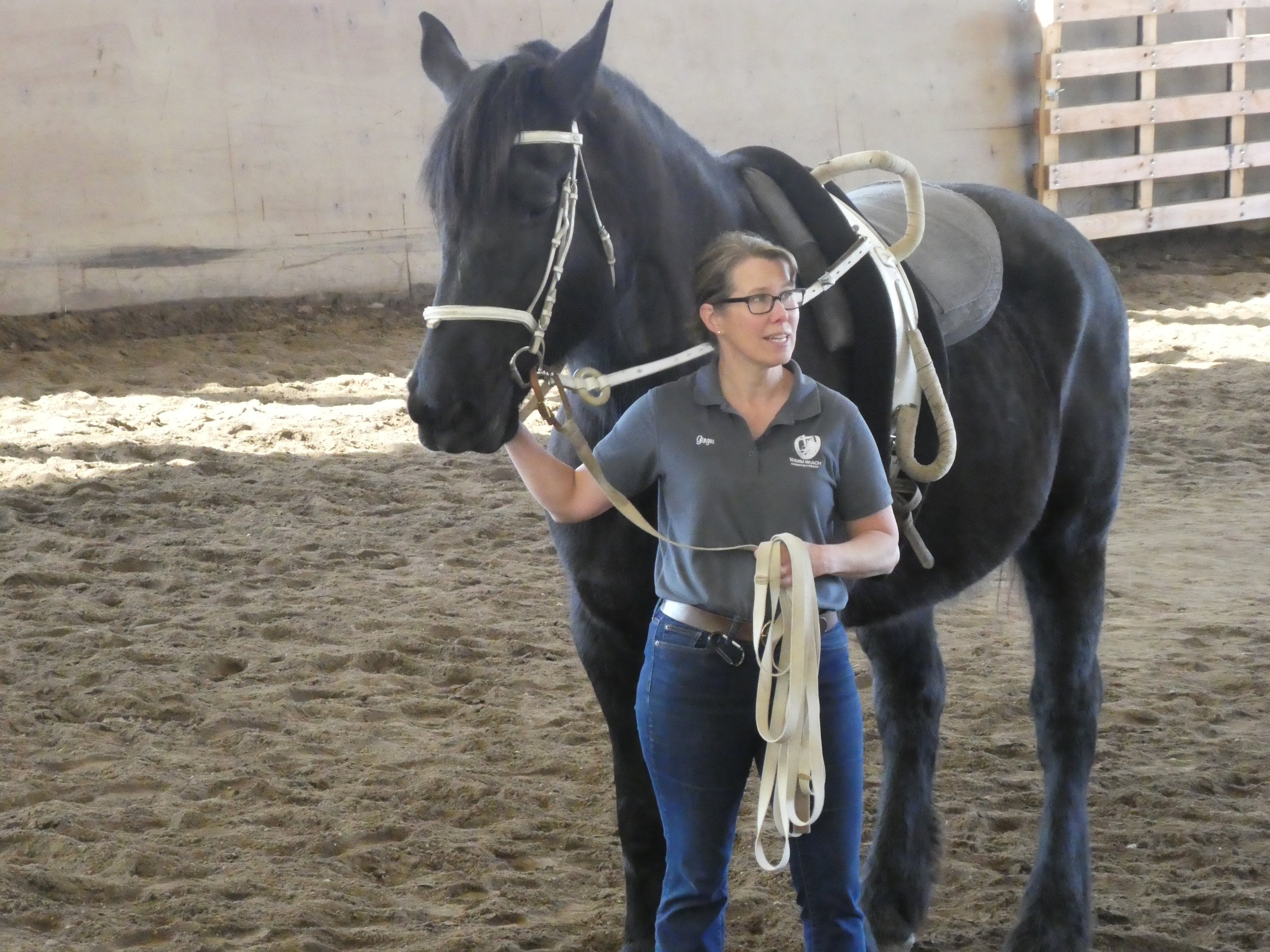 Ginger Reitz, Therapeutic Horsemanship Coordinator, with Freya in the vaulting surcingle.