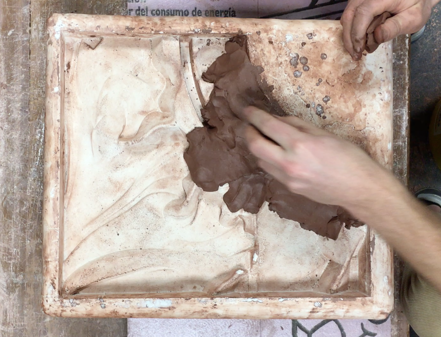 Students pressing clay into the molds