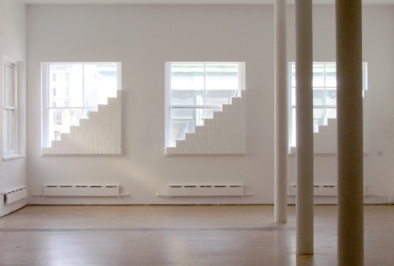 Installation for three windows , 2013. 243 hand-sanded Styrofoam bricks. Dimensions variable. Installation view