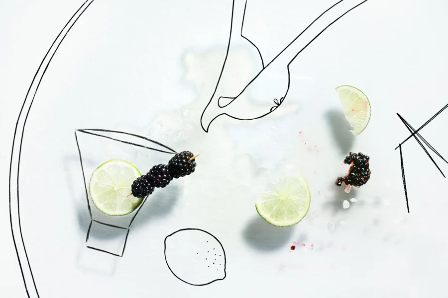 Creative multi-media food photography, spilled blackberry margarita drink