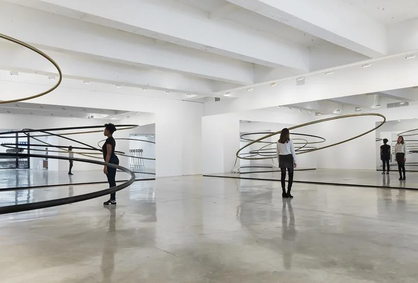 The railings complete their circles in the reflections of the mirror. They repeat in an endless mirror effect. (Photo: http://www.tanyabonakdargallery.com/exhibitions/olafur-eliasson_9/6