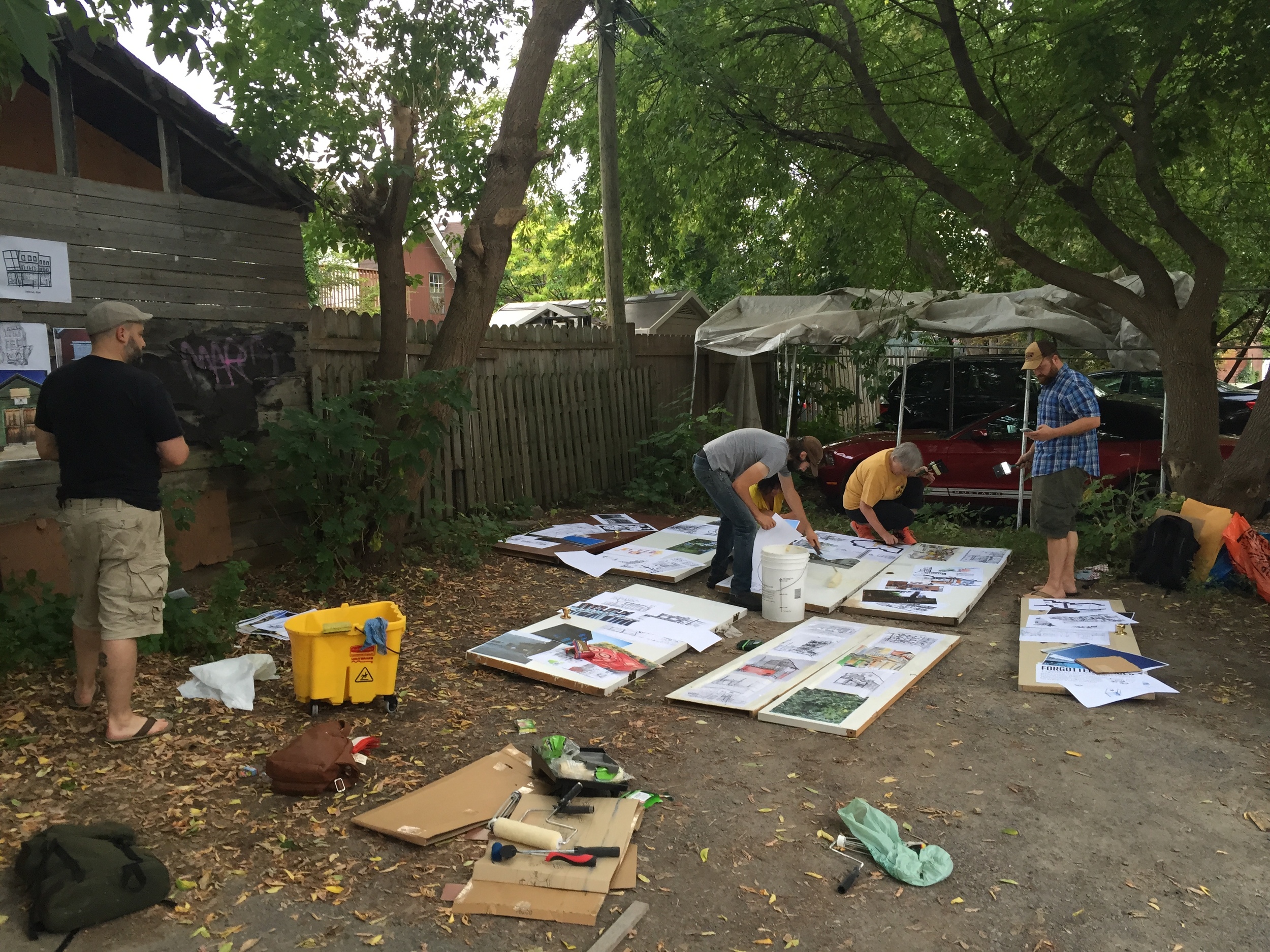 (Stephen, Mawt, Kristina, Cindi and Marc wheat pasting art onto doors) 