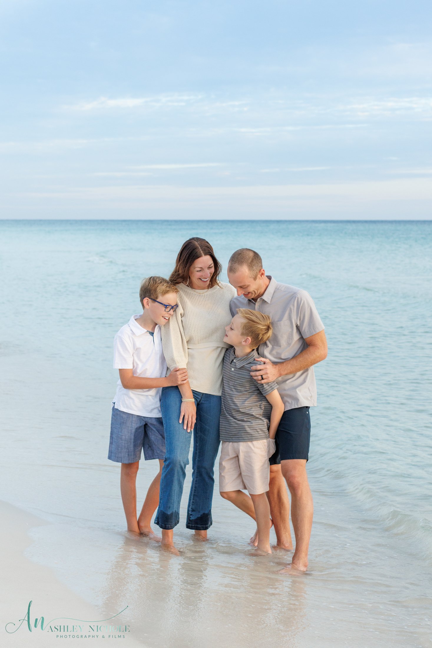 a family of four at sunset having their family portraits taken in seaside along 30a