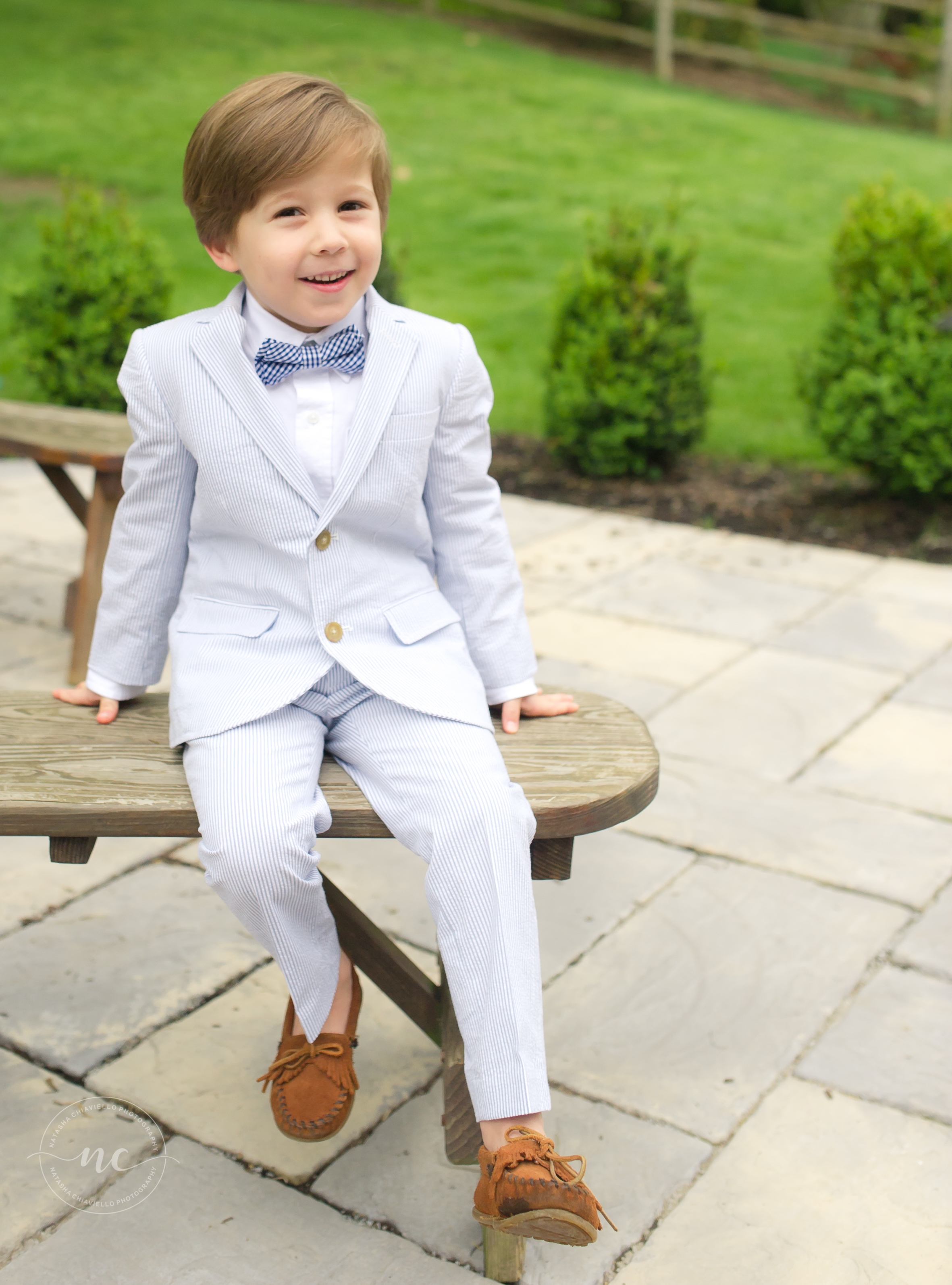 little boy in a suit and bowtie