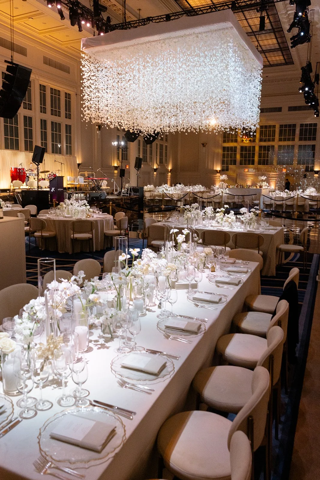 A long candlelit reception table under a crystal chandelier at Cipriani South Street