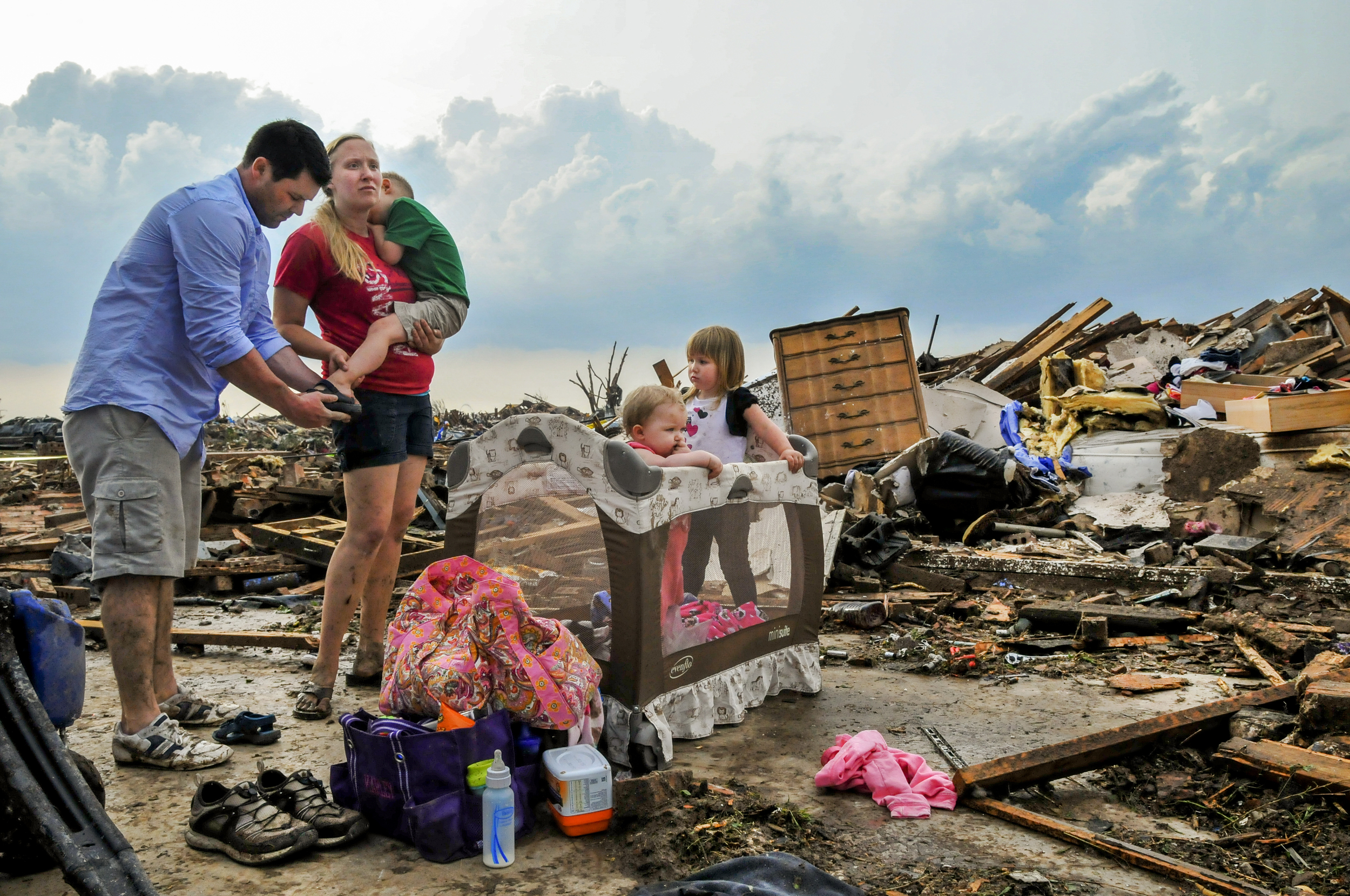  Kelcy Trowbridge, her brother in Law Dustin Weher and her three children L to R: Colby Trowbridge&nbsp; 4, Karley Trowbridge, 1, and Kynlee Trowbridge in front of their destroyed home on May, 20 in the Westmoor Neighborhood near Moore Oklahoma. 