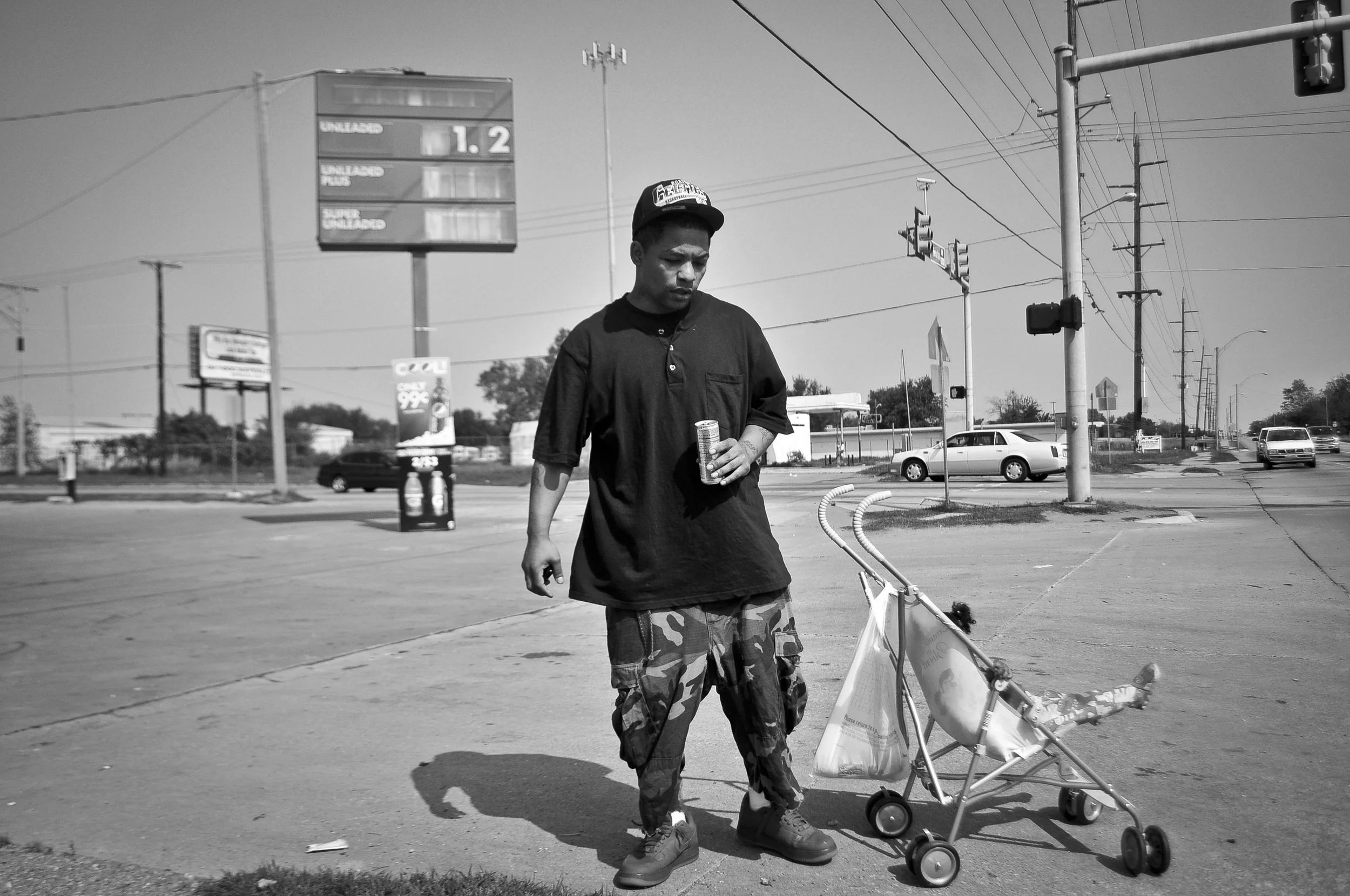 Carl Moore stands along N. Peoria Ave. with his daughter in North Tulsa. Moore came to Tulsa from Houston to escape the problems plaguing the neighborhood he was living in. Nick Oxford for The New York Times