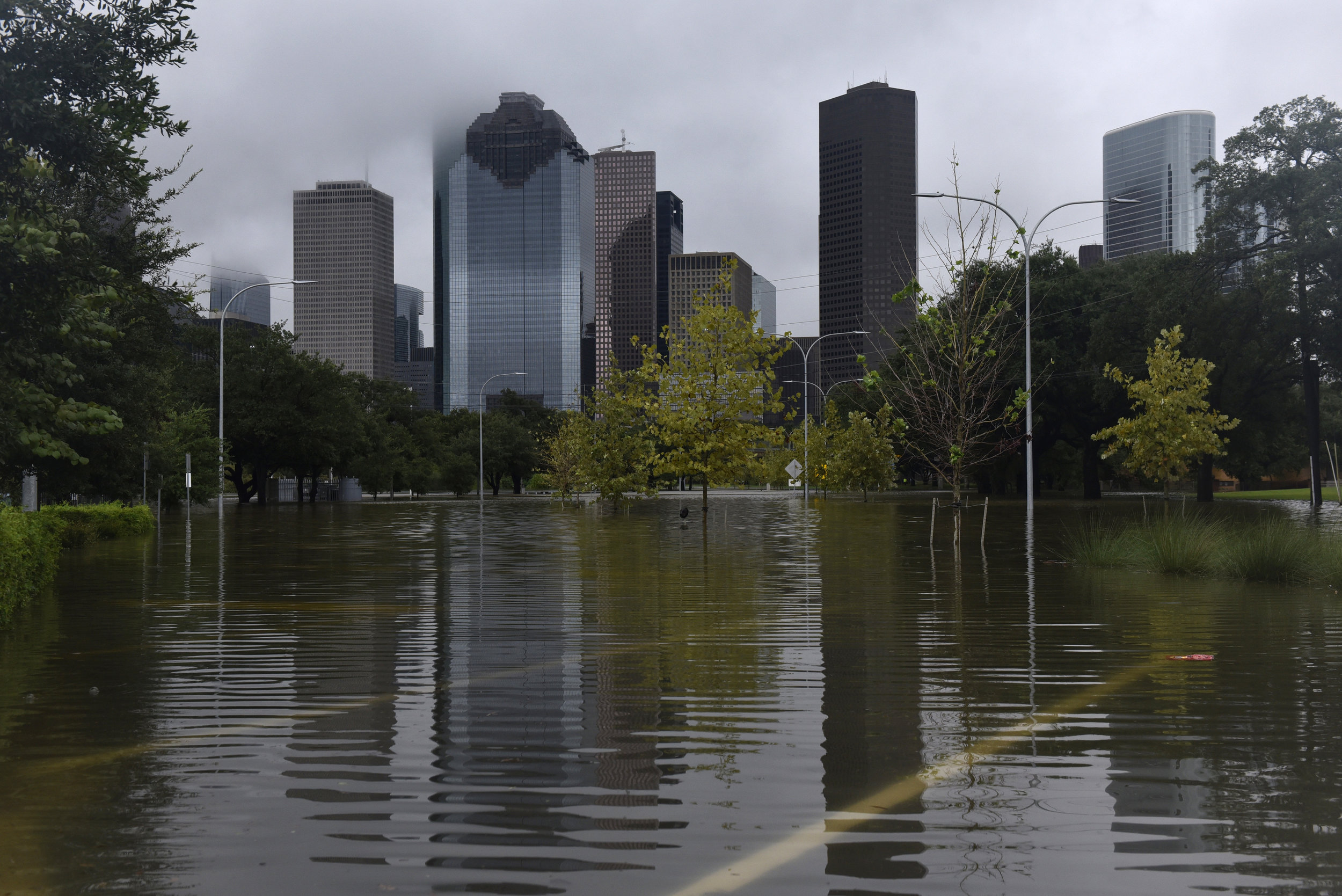  The downtown skyline is reflected in flood water in Buffalo Bayou Park after Hurricane Harvey inundated the Texas Gulf coast with rain causing widespread flooding, in Houston, Texas, U.S. August 27, 2017.  REUTERS/Nick Oxford 