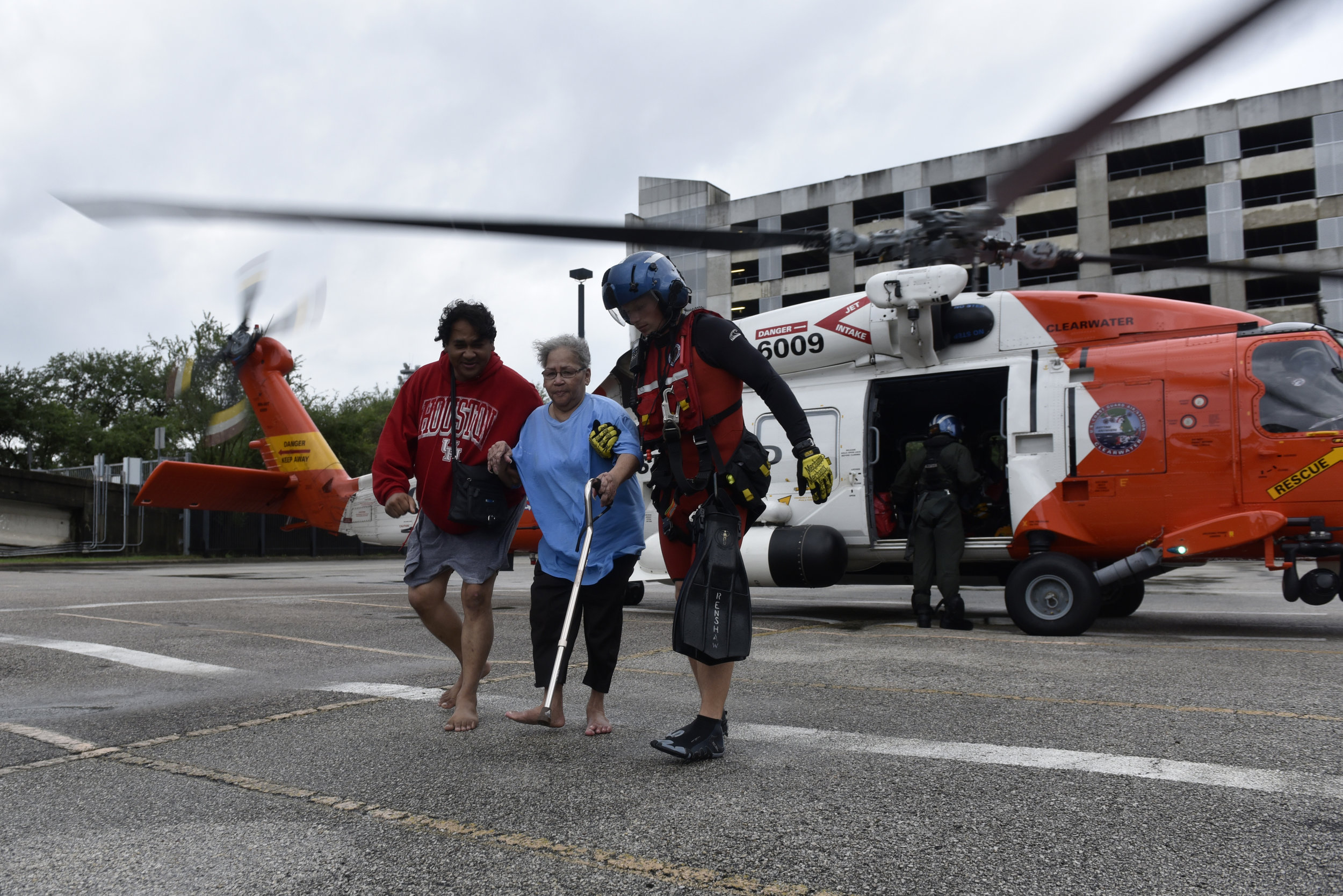  Evacuees Rickey Manuel (L) and Marjory Manuel (C) exit a U.S. Coast Guard helicopter that rescued them after Hurricane Harvey inundated the Texas Gulf coast with rain and flooded their home, in Houston, Texas, U.S. August 27, 2017.  REUTERS/Nick Oxf