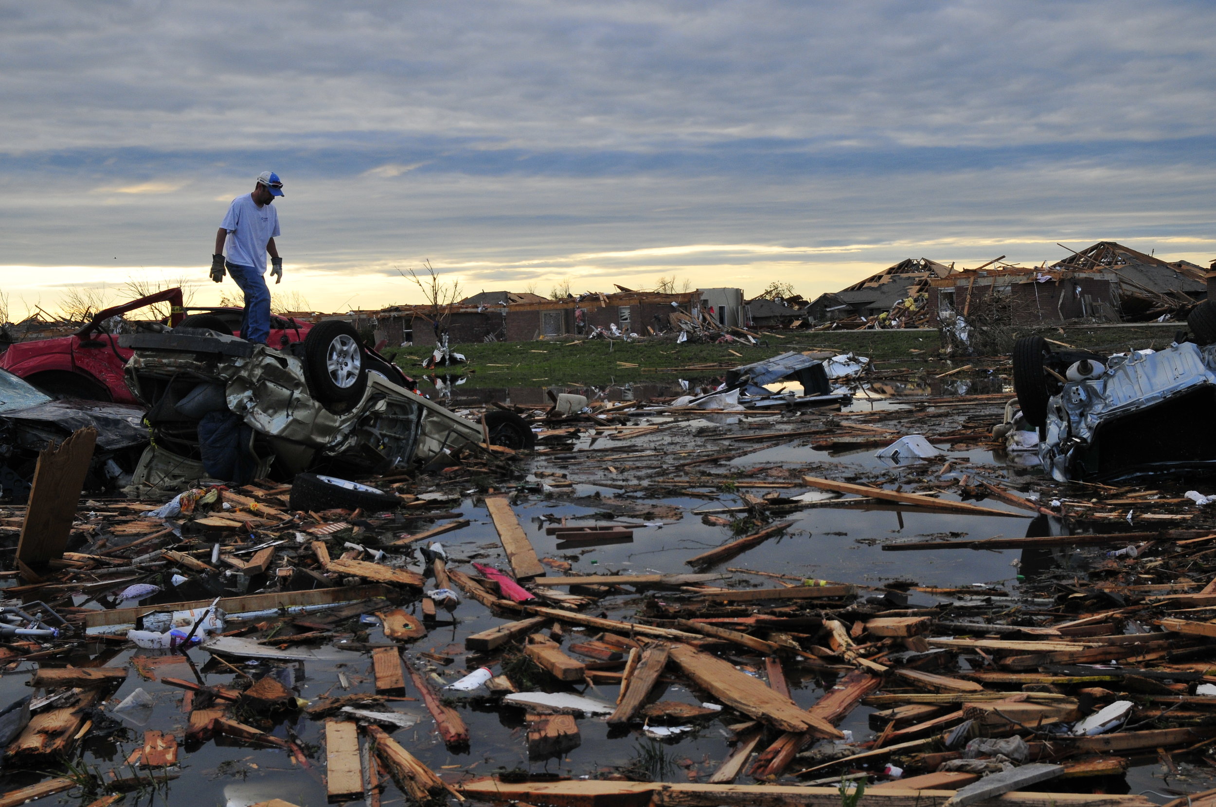  Mark Heflin searches for some belongings in a pond full of debris and cars in a neighborhood that took a direct hit from yesterdays tornado on May, 21 in Moore Oklahoma 