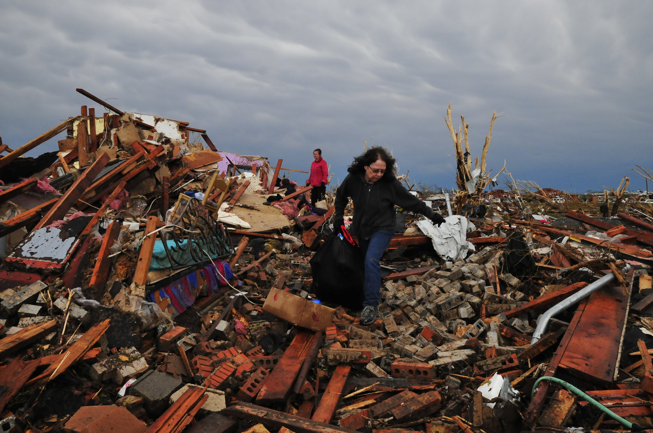  Debbie Mayhle, right, and her daughter Kristi Jones retrieve some of Debbie's belongings from her home which was in the direct path of yesterdays tornado on May, 21 in Moore Oklahoma. 