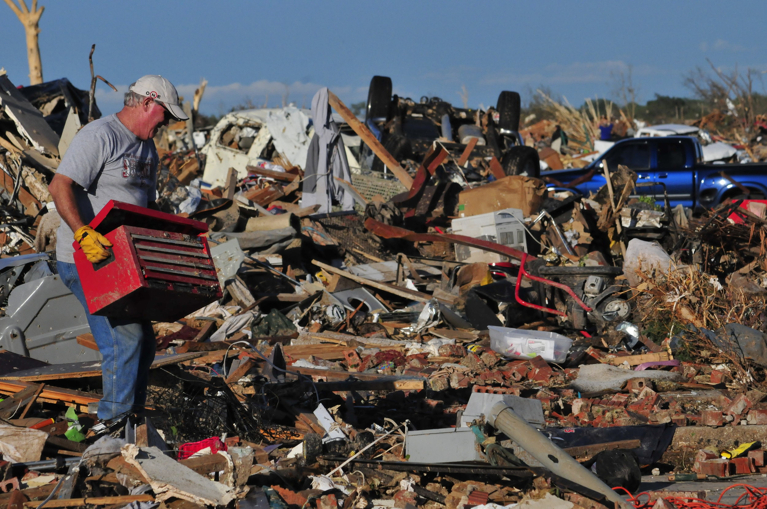  Robert Dixon removes a toolbox from his sons leveled home on May, 21 in Moore Oklahoma 