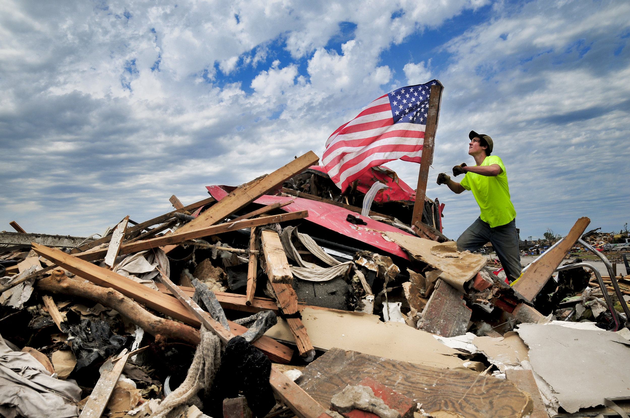  Franklin Van Beckum, a volunteer from Edmond, hangs a flag that he found amid the destruction on Thursday, May 23 in Moore OK.

PHOTO SENT ON SPEC 
