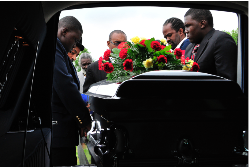 Pallbearers lift the coffin of Bobby Clark, who was shot and killed in North Tulsa on Good Friday, out of the hearse at his funeral. Nick Oxford for The New York Times