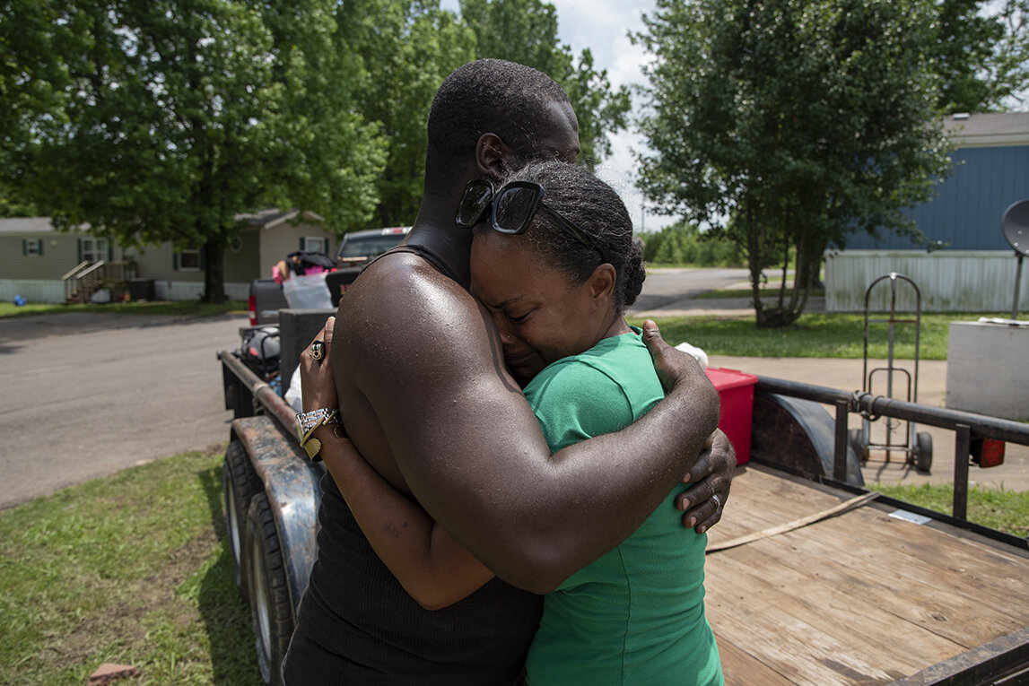  Tamicka Green is comforted by her husband Jackie Green as they prepare to evacuate from the Riverside Manufactured Home Community in Muskogee, Oklahoma. Nick Oxford for The New York Times 