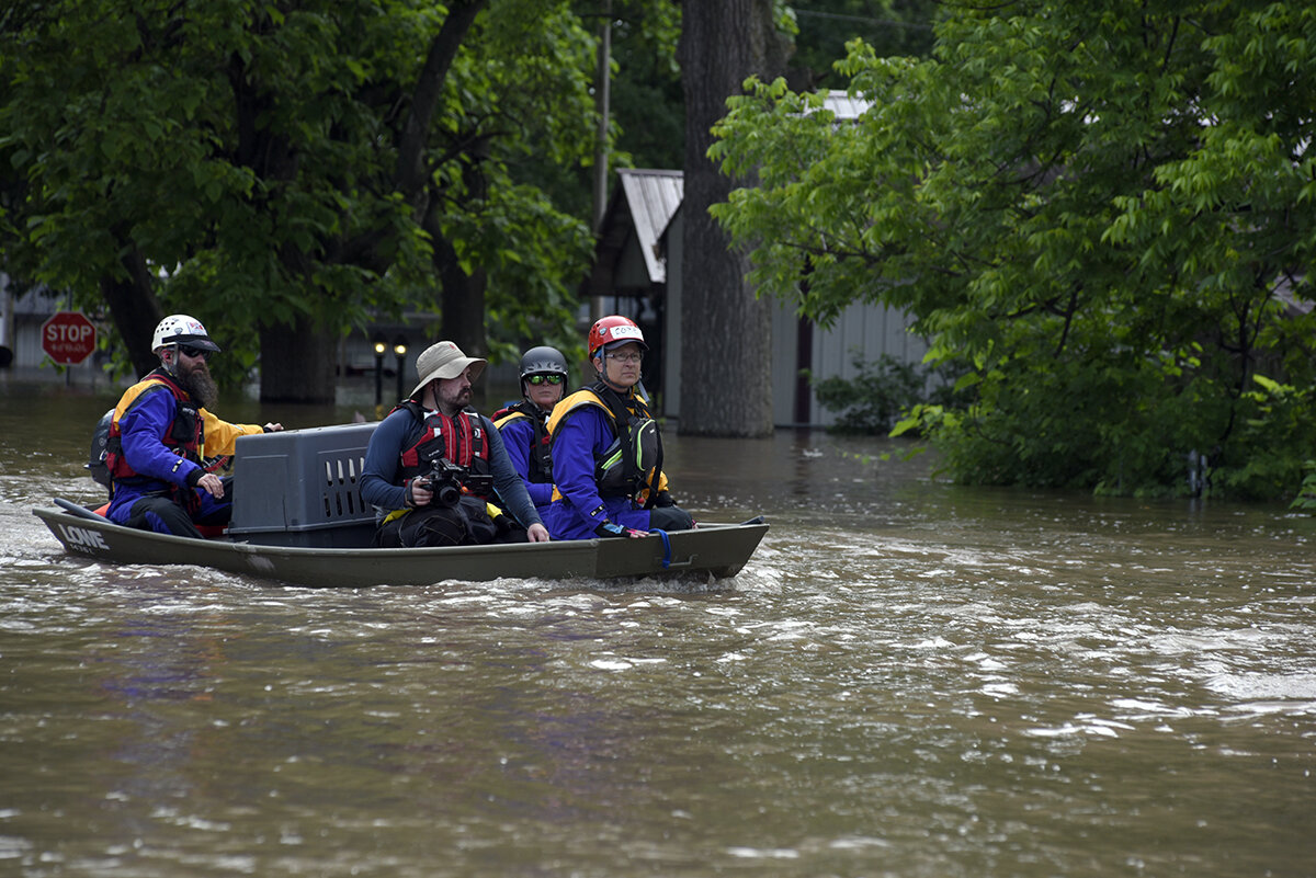  An animal rescue team navigates through flooded streets in Webber's Falls, Oklahoma. Nick Oxford for The New York Times 