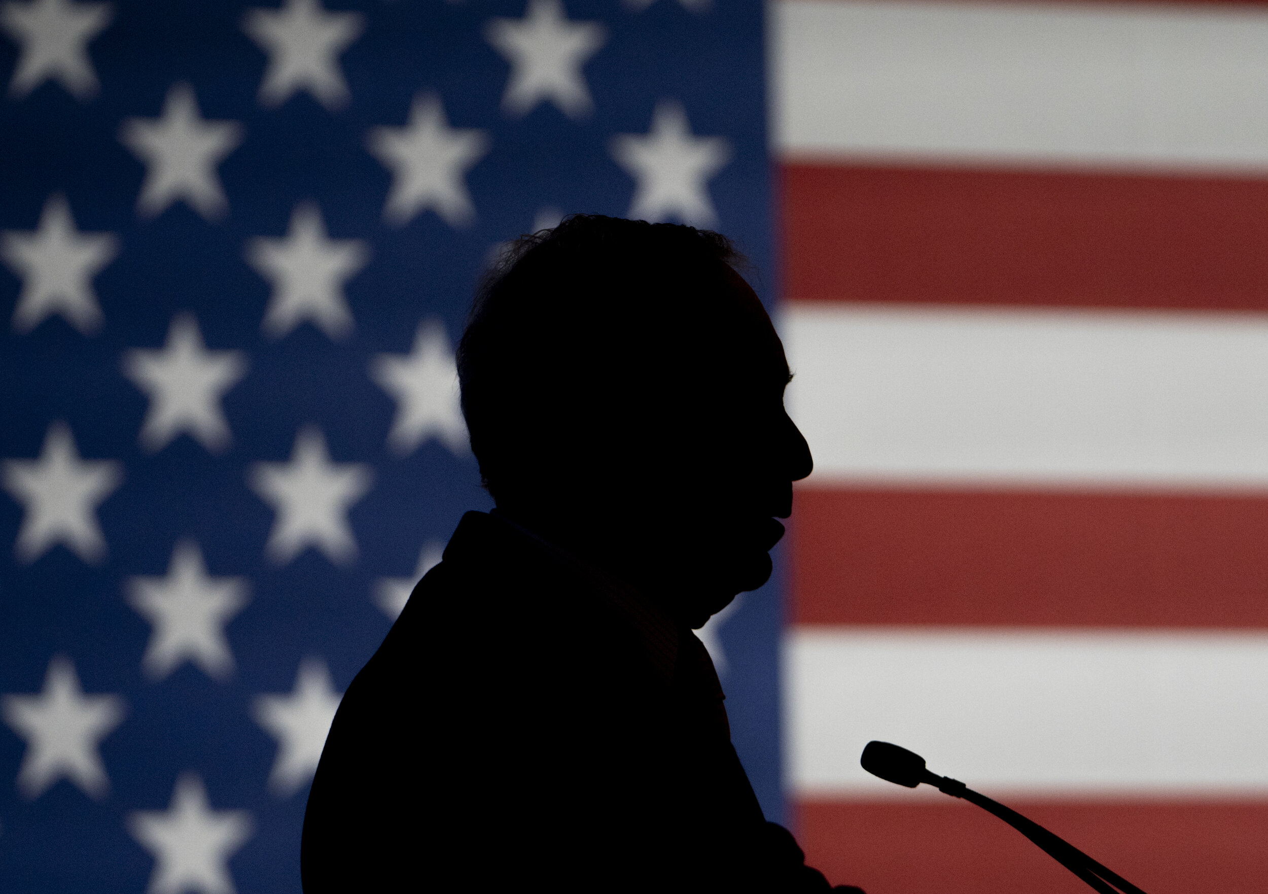 Democratic presidential candidate Mike Bloomberg is silhouetted against a flag during a campaign stop at the Oklahoma History Center in Oklahoma City. 