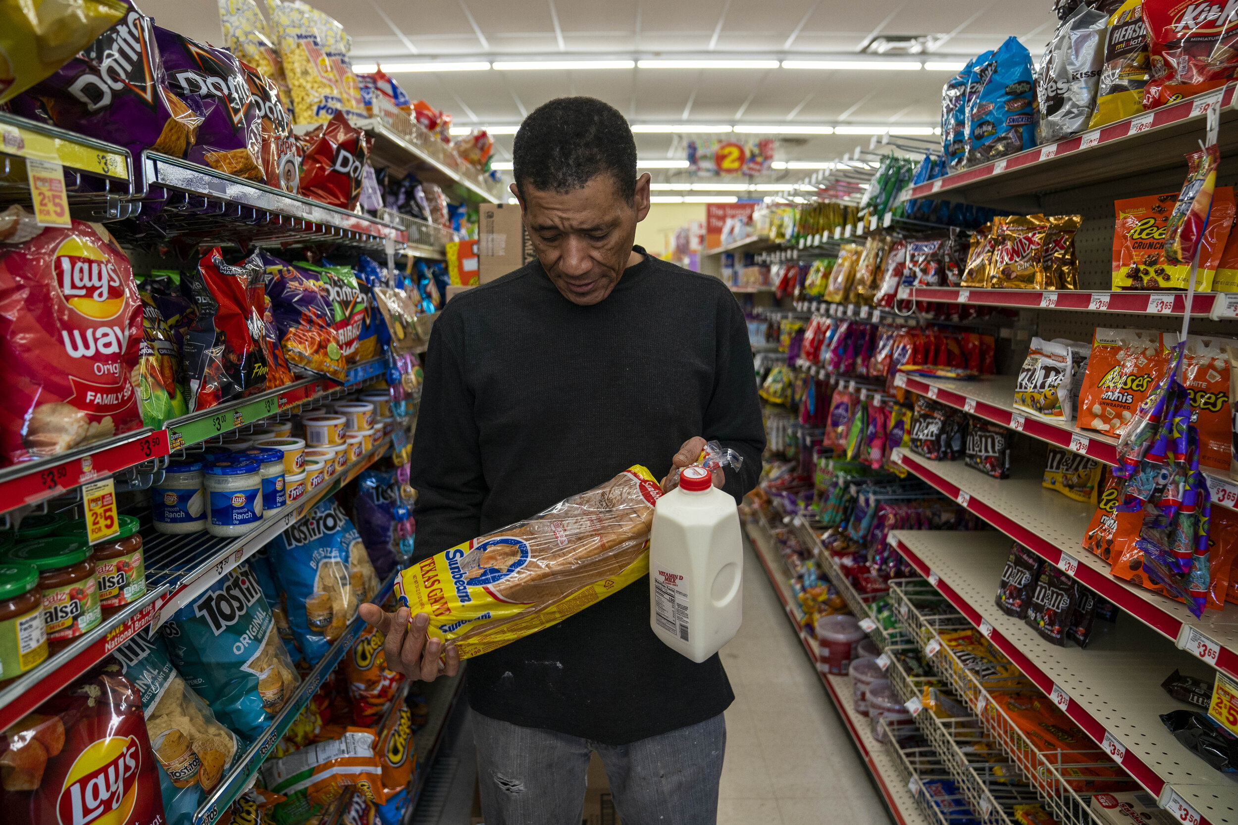  Gregory McCauley picks up some bread and milk at Family Dollar during his break in Oklahoma City, Oklahoma, December 13, 2019. Dollar stores are the only available grocery’s available in Gregory’s zip code which is classified as a Food Desert. Nick 