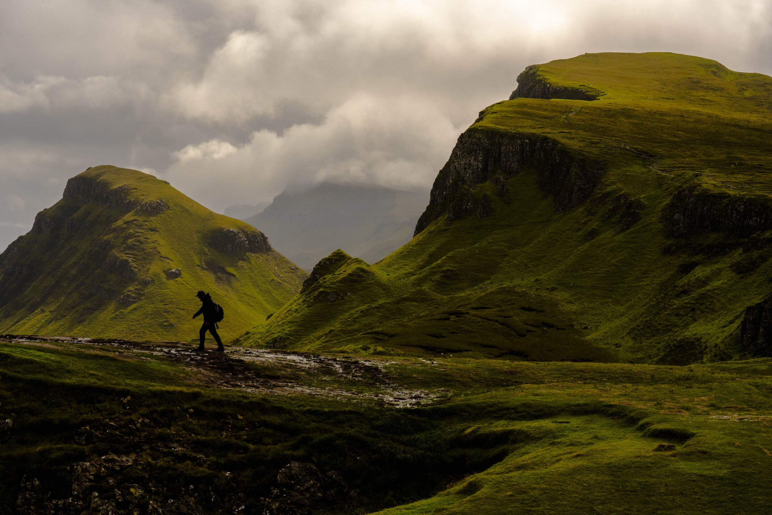  A hiker climbs The Quirang on Isle of Skye, Scotland 